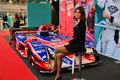 Le hostess che affiancano una monoposto da competizione al Bologna Motor Show 2012