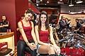 Simpatiche ragazze sorrineti su moto Indian Motor Cycle allEicma 2013 Salone del motociclo di Milano