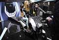 Scooter cinese Vmoto Fleet VS1 e sexy ragazza in tuta attilata allEicma 2021 di Milano al Salone del Motociclo a Fiera Rho