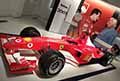 Monoposto Formula 1 Ferrari F2003 GA esposta all´Officina Alfonso Ferrari con la gigantografia di Gianni Agnelli che parla con Michael Schumacher del 1997 al Museo Ferrari di Modena
