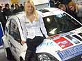 Hostess seduta sul cofano della Ford racing car al Motor Show di Bologna 2009